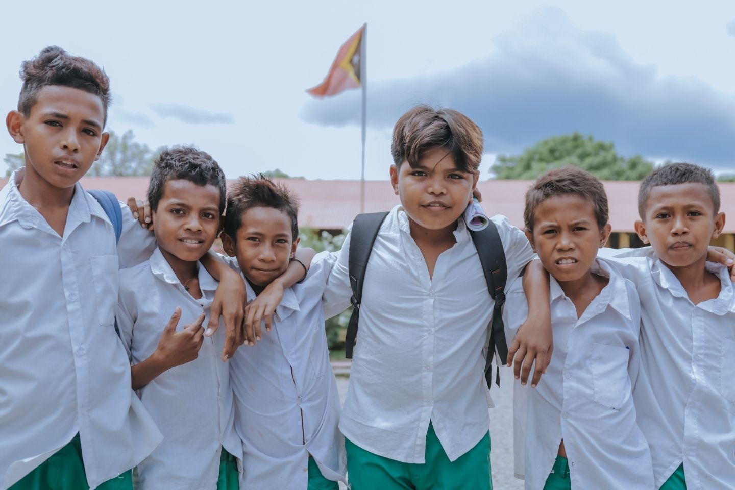 A group of six male school students pose for the camera.