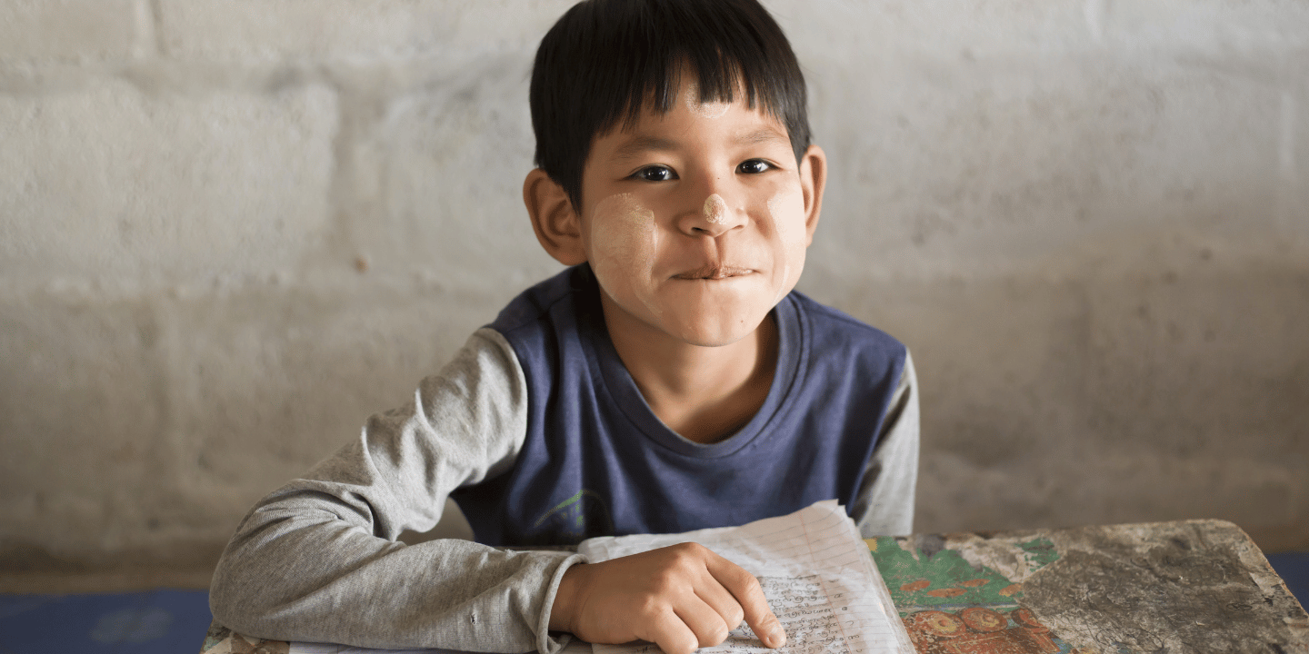 Karen boy from Myanmar learns on Thai border.