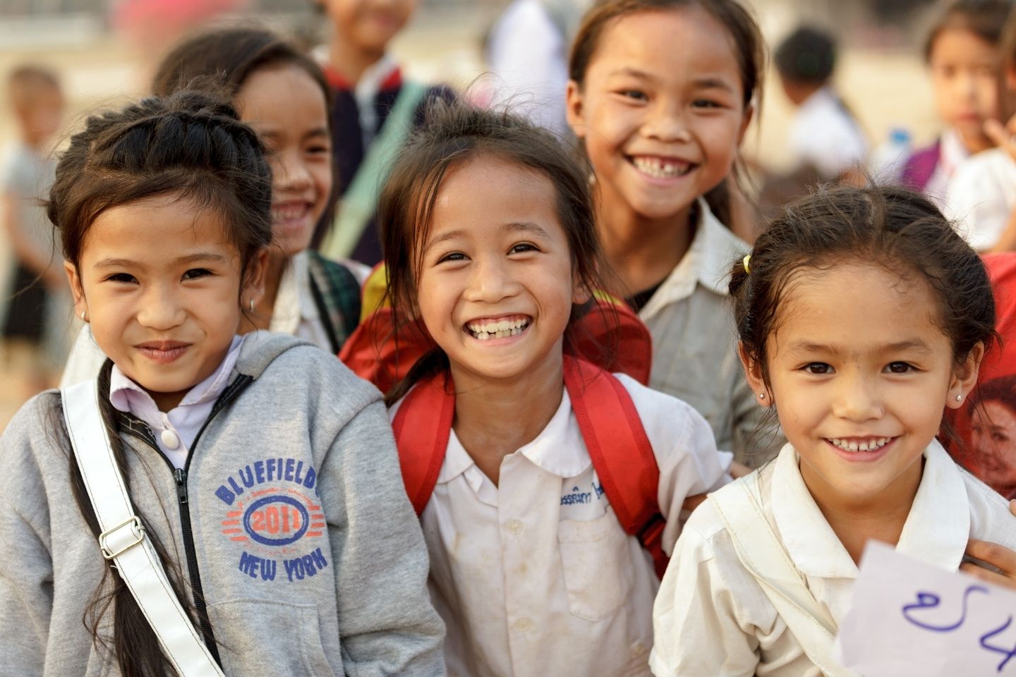 School girls in Lao PDR smiling at the camera.