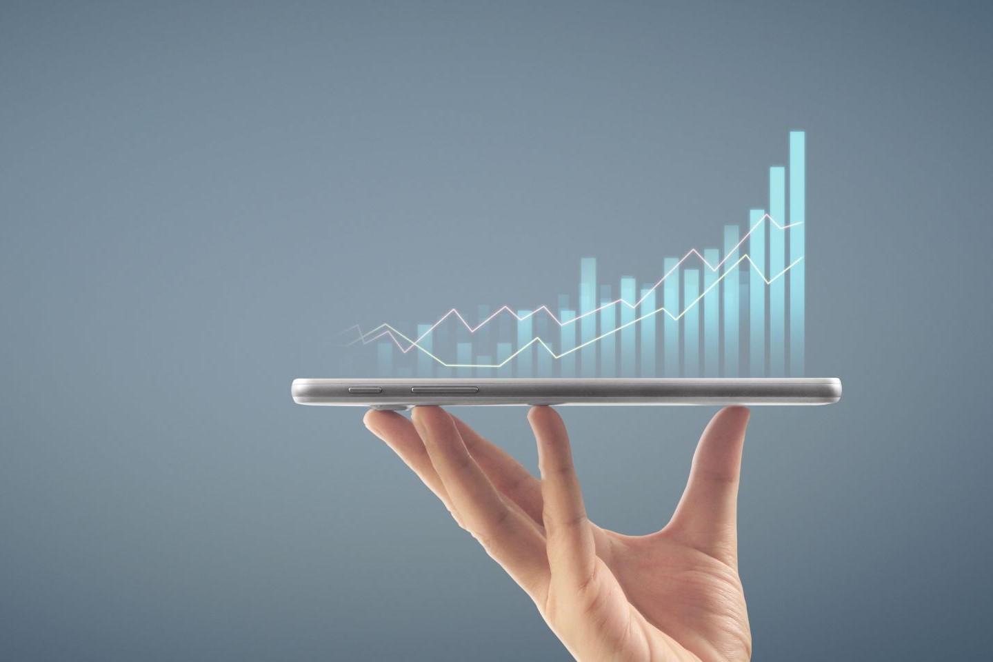 Hand holding chart showing growth